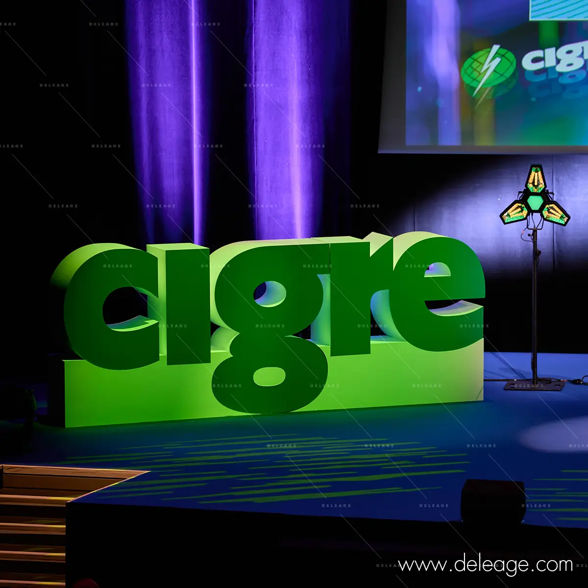 2-logo-cigre-volume-eclairage-scene-palais-congres Logo CIGRE en volume sous les projecteurs, rideau violet en fond, scène du CIGRE 2026 à Paris